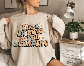 'Fall in Love with Learning' Teacher Crewneck Sweatshirt in green, pink, white and tan